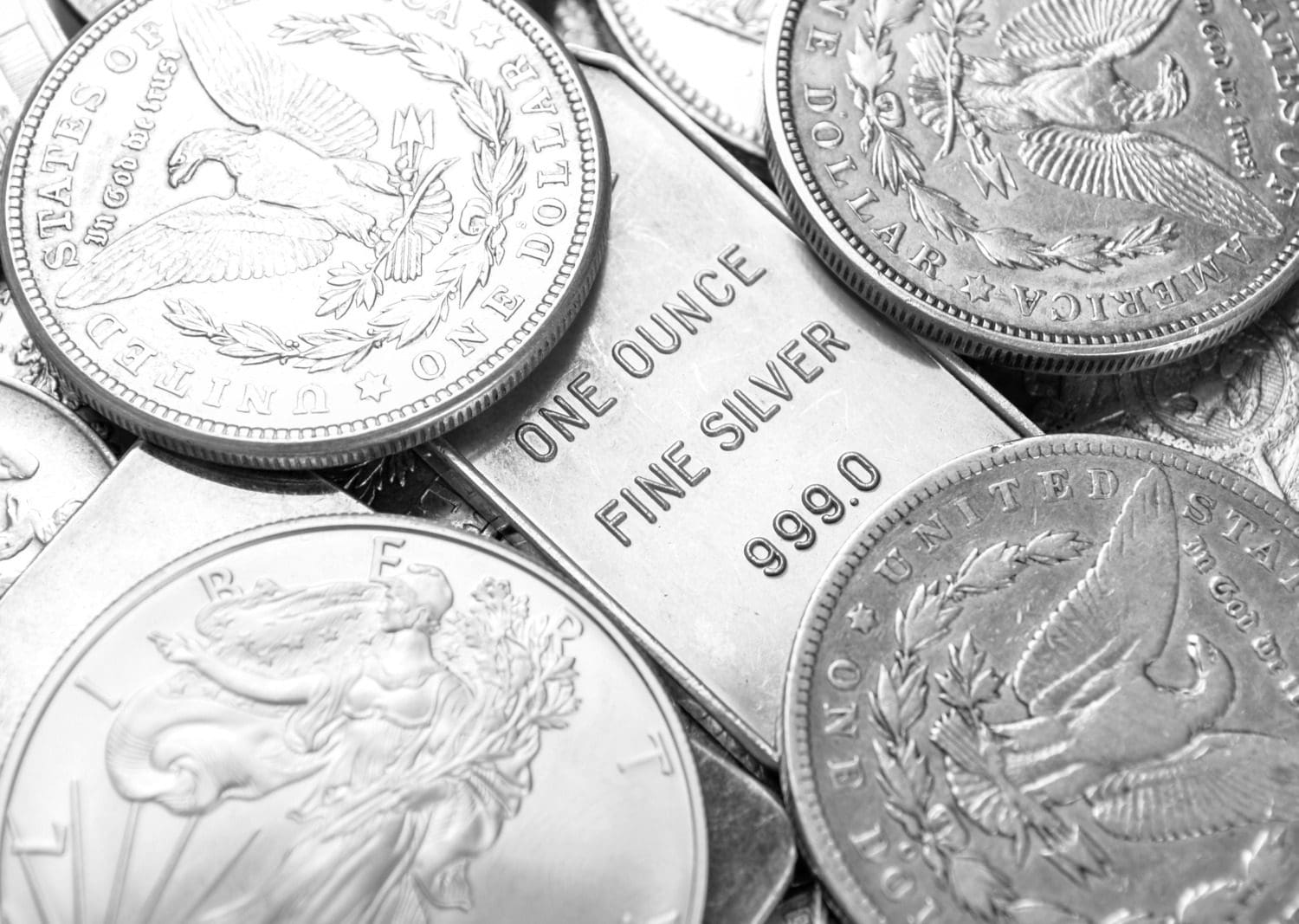 Detailed photograph of silver coins and a silver bar representing commodity asset allocations.
