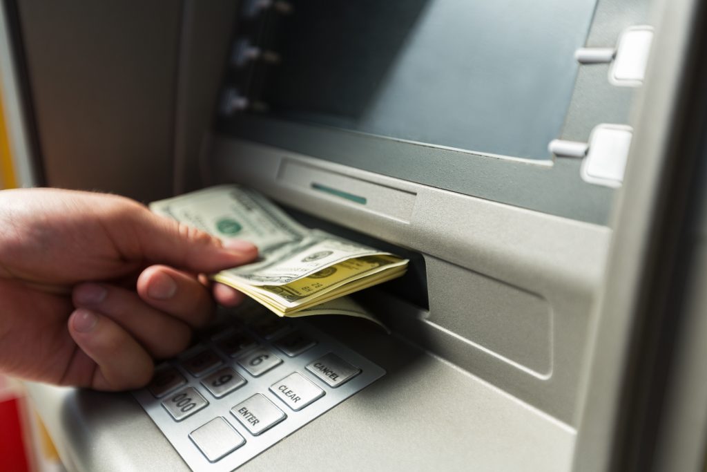 Man make a cash deposit to ATM