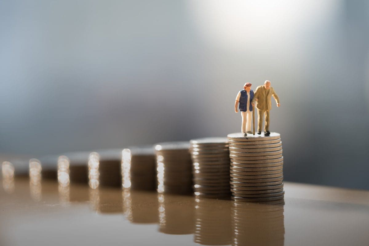 A symbolic representation of long-term care planning featuring elderly figures on a stack of coins.