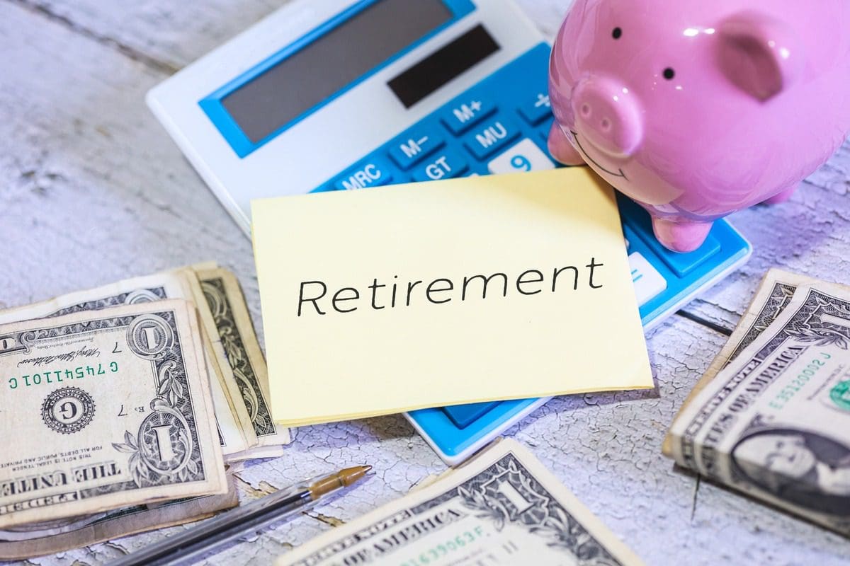 A piggy bank on a calculator symbolizing retirement planning and savings.