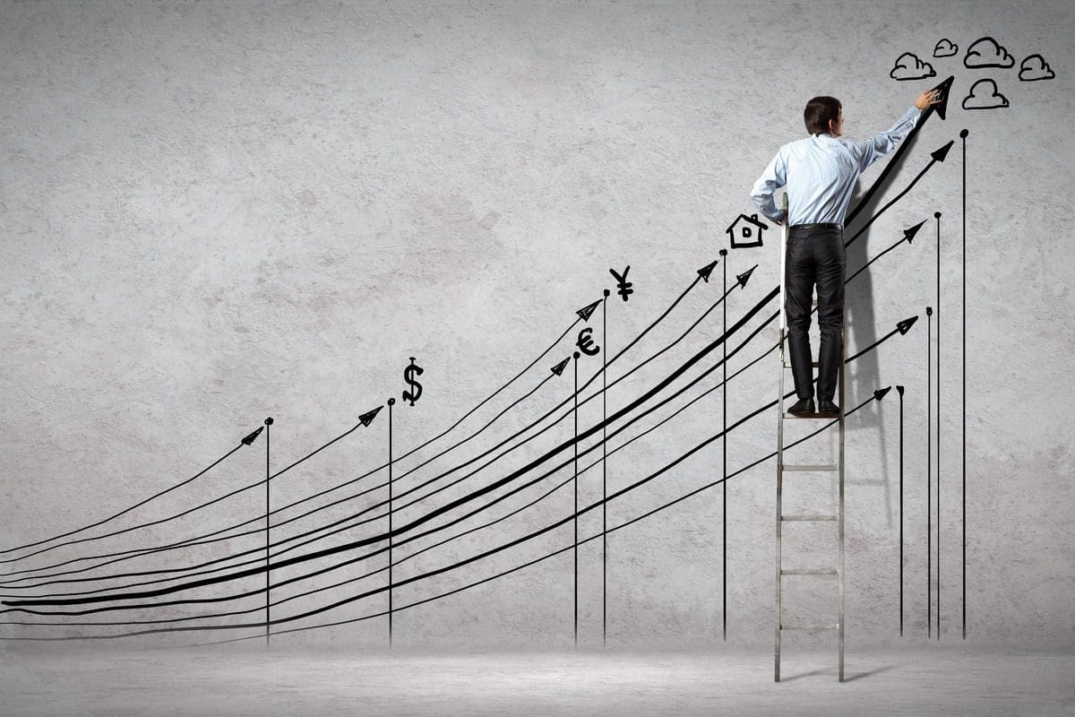 Man on ladder drawing upward lines with currency symbols.