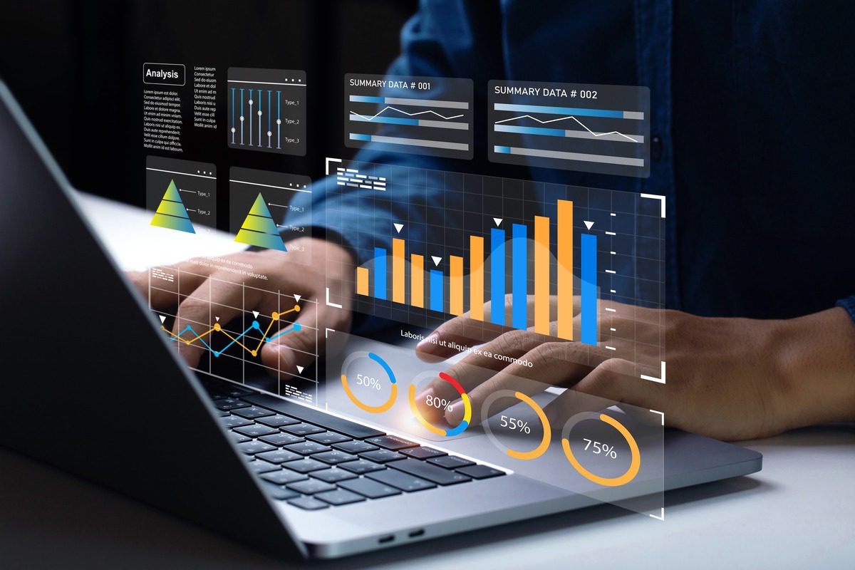 Laptop screen displaying digital financial charts and market analysis graphs
