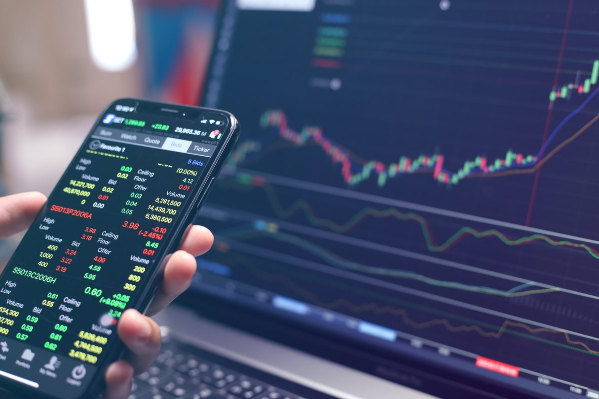 A mobile device displaying real-time cryptocurrency market data and price charts.
