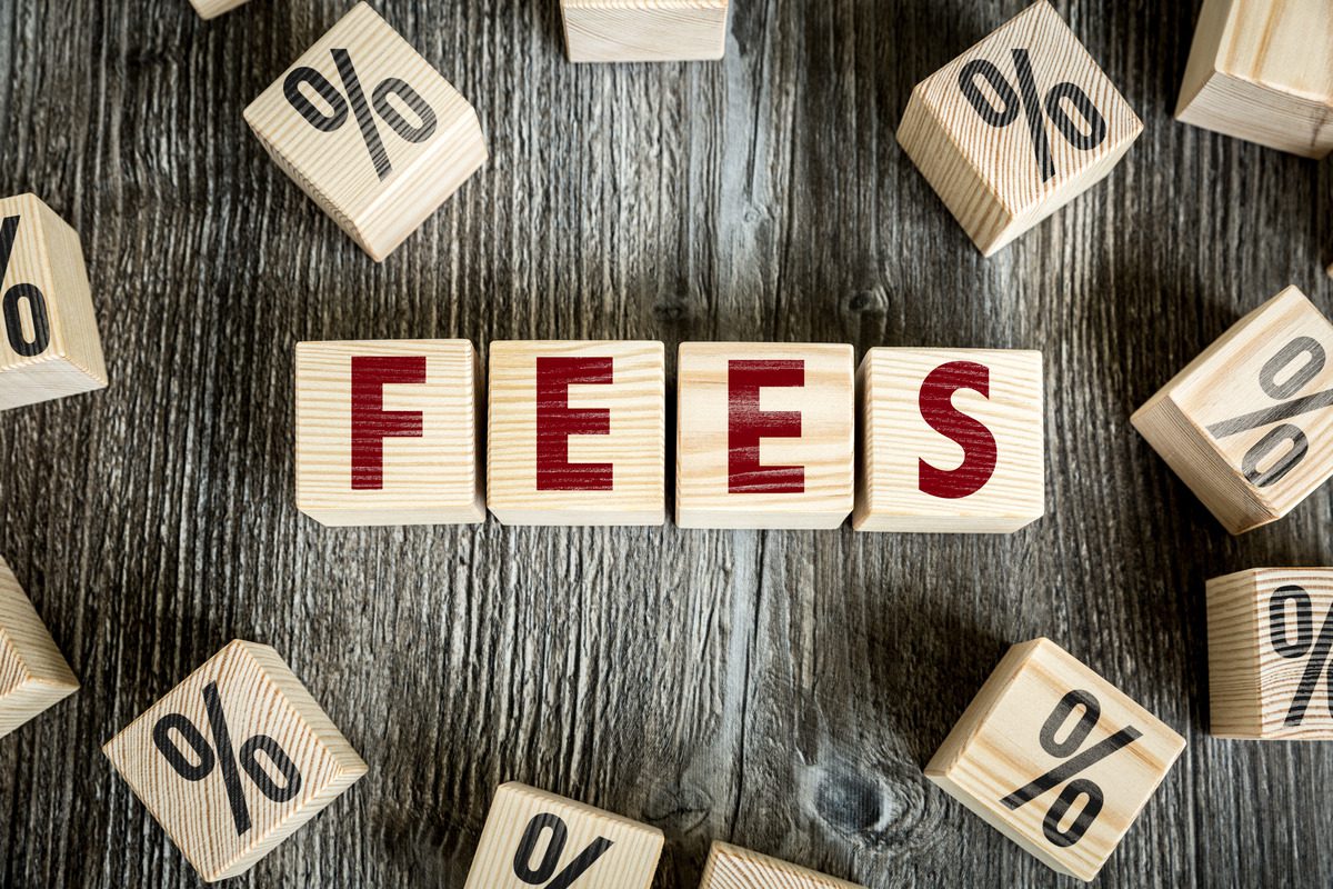 Close-up of wooden blocks spelling out FEES with percentage symbols.